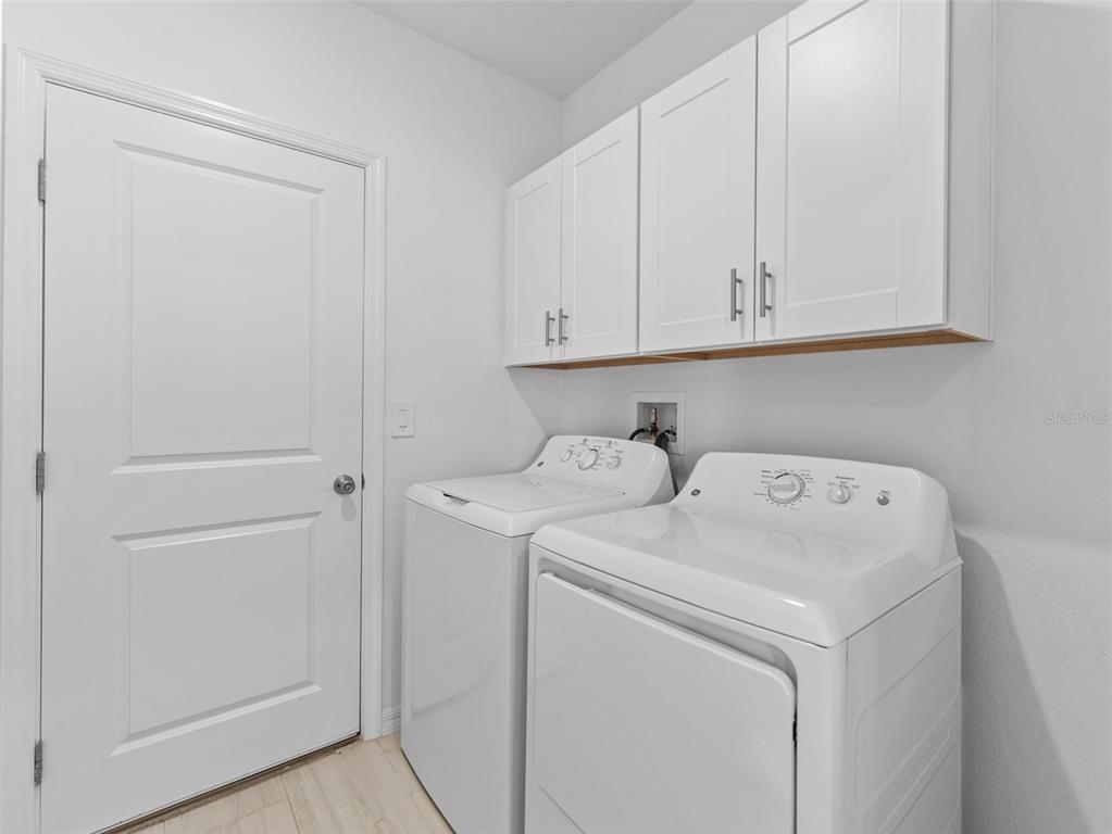 11628 Radiant Shr Loop San Antonio, FL 33576 - Photo 14 of 16 a view of storage and utility room with washer and dryer