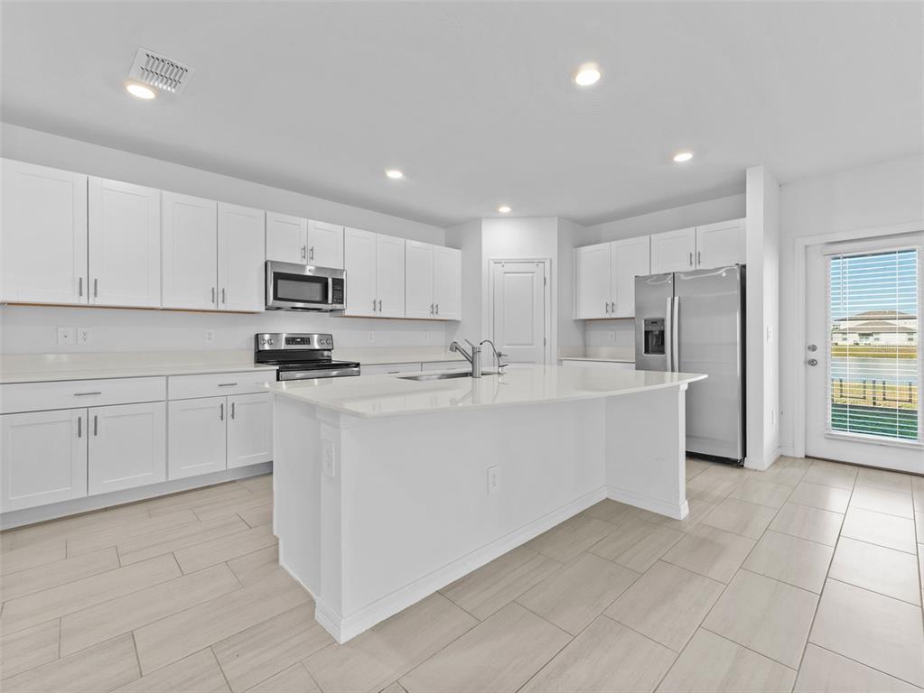 11628 Radiant Shr Loop San Antonio, FL 33576 - Photo 3 of 16 a kitchen with cabinets and a refrigerator