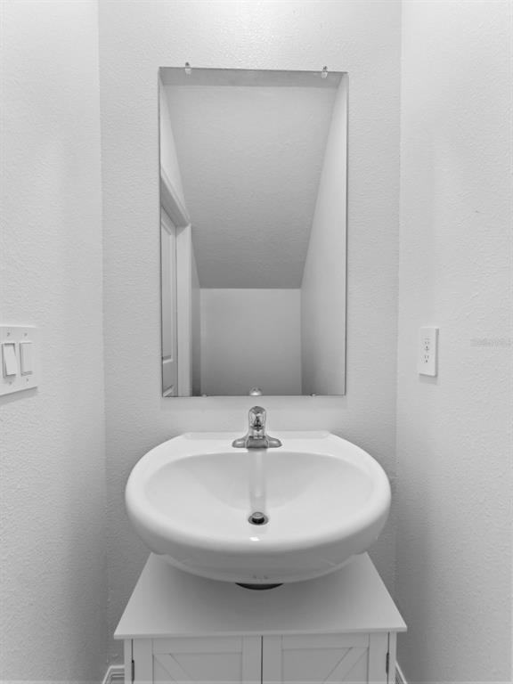 11628 Radiant Shr Loop San Antonio, FL 33576 - Photo 5 of 16 a bathroom with a sink and a mirror