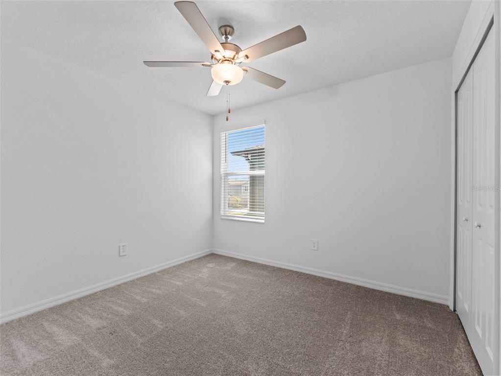 11628 Radiant Shr Loop San Antonio, FL 33576 - Photo 10 of 16 an empty room with a window and a ceiling fan