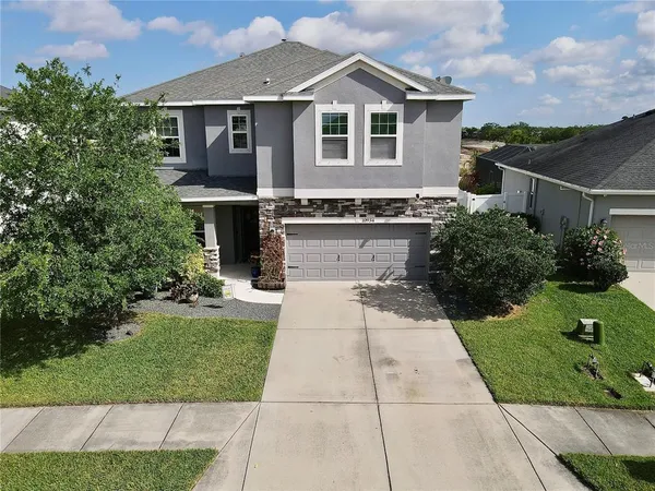 a front view of house with yard and green space