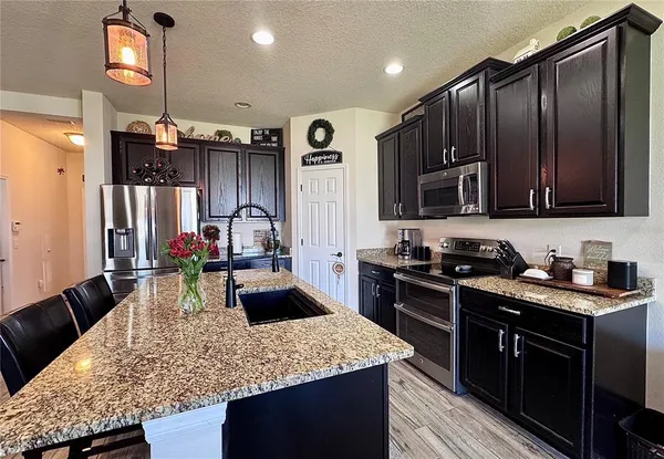 a kitchen with a stove and a refrigerator