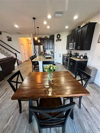 a view of a dining room with furniture window and wooden floor