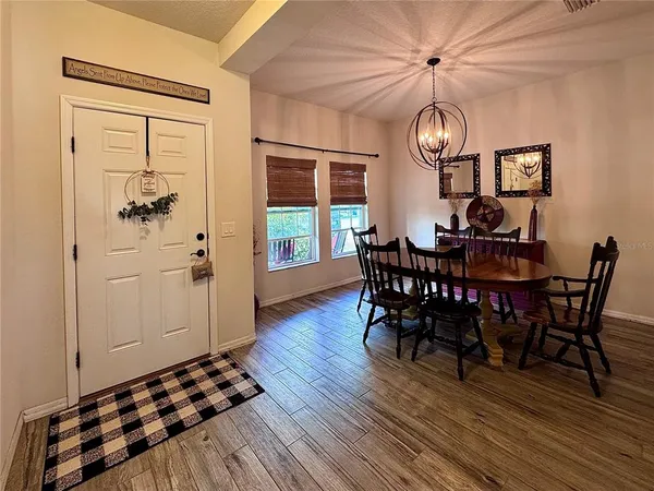 a view of a dining room with furniture wooden floor and chandelier