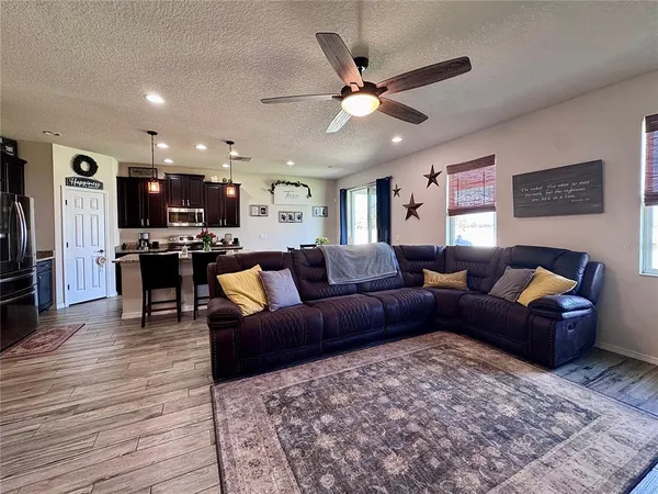 a living room with furniture and a flat screen tv with wooden floor