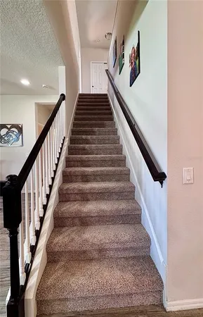 a bedroom with a bed wooden floor and window
