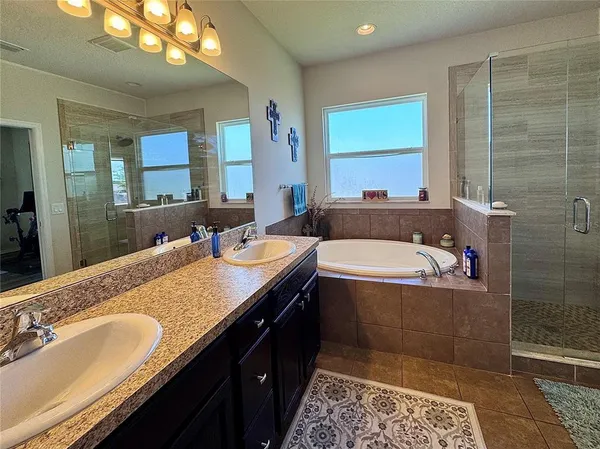 a bathroom with a bathtub and a shower