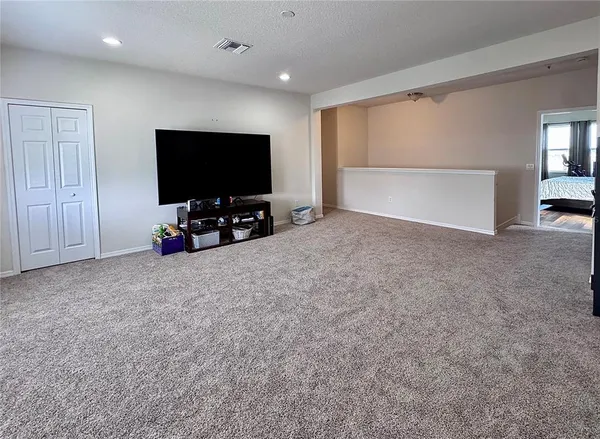 a large bedroom with bed and furniture