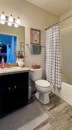 a bathroom with a toilet sink and shower