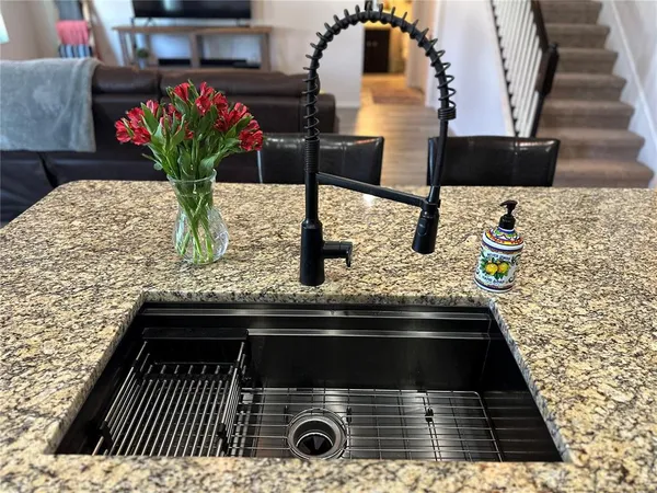 a kitchen with granite countertop stainless steel appliances and wooden cabinets