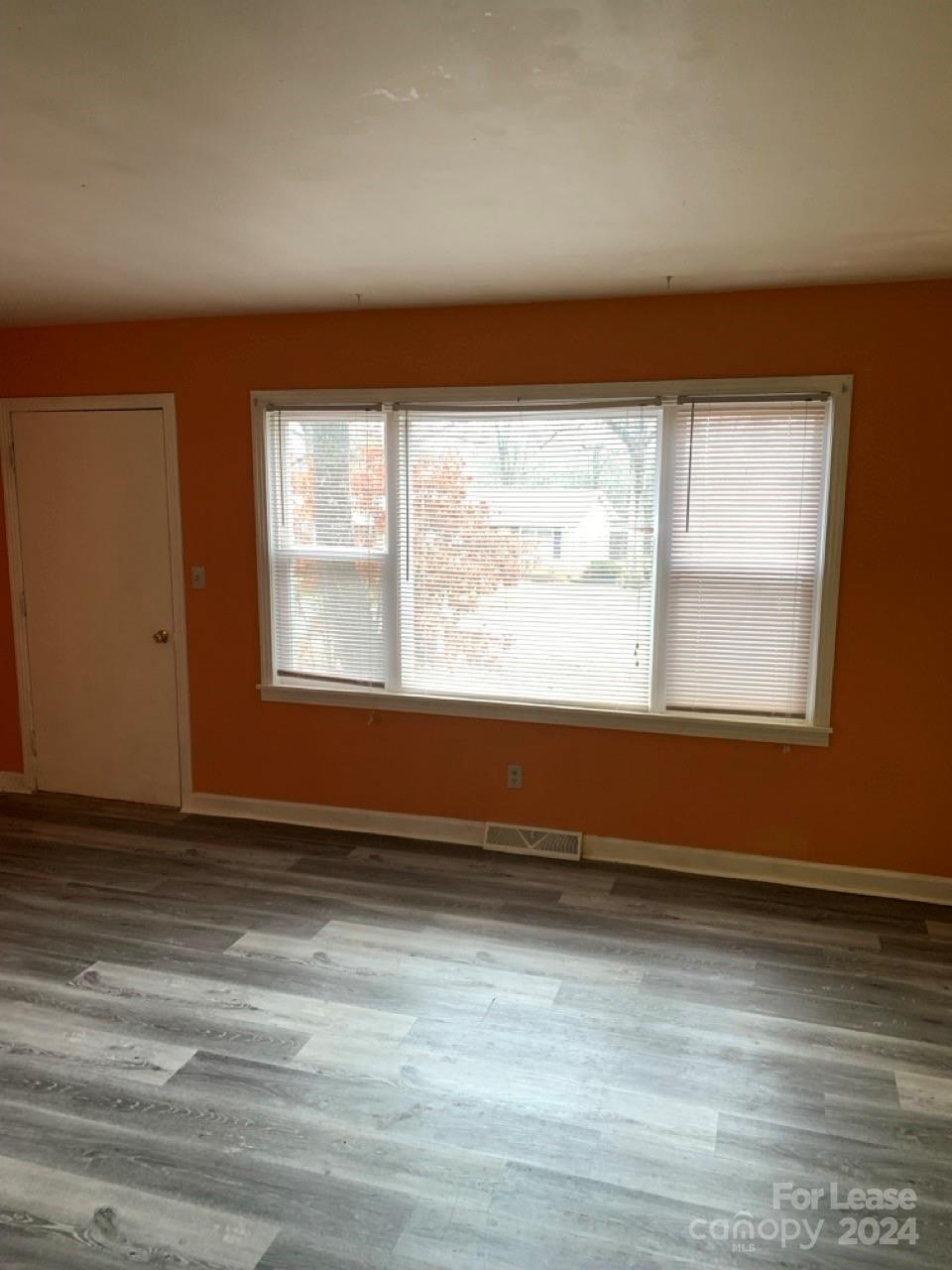 44177 B Mountain View Church Road Albemarle, NC 28001 - Photo 4 of 26 a view of an empty room with wooden floor and a window