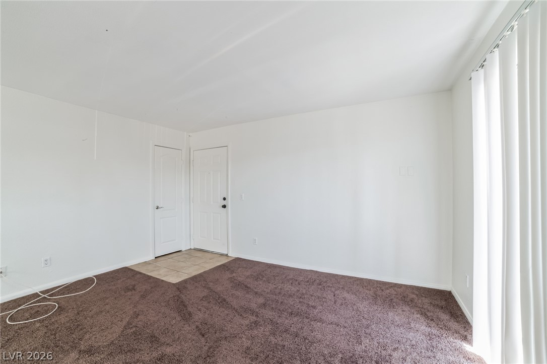 7200 West Pirates Cove Road, Unit 1049 Las Vegas, NV 89145 - Photo 2 of 12 Unfurnished room featuring carpet floors and baseboards