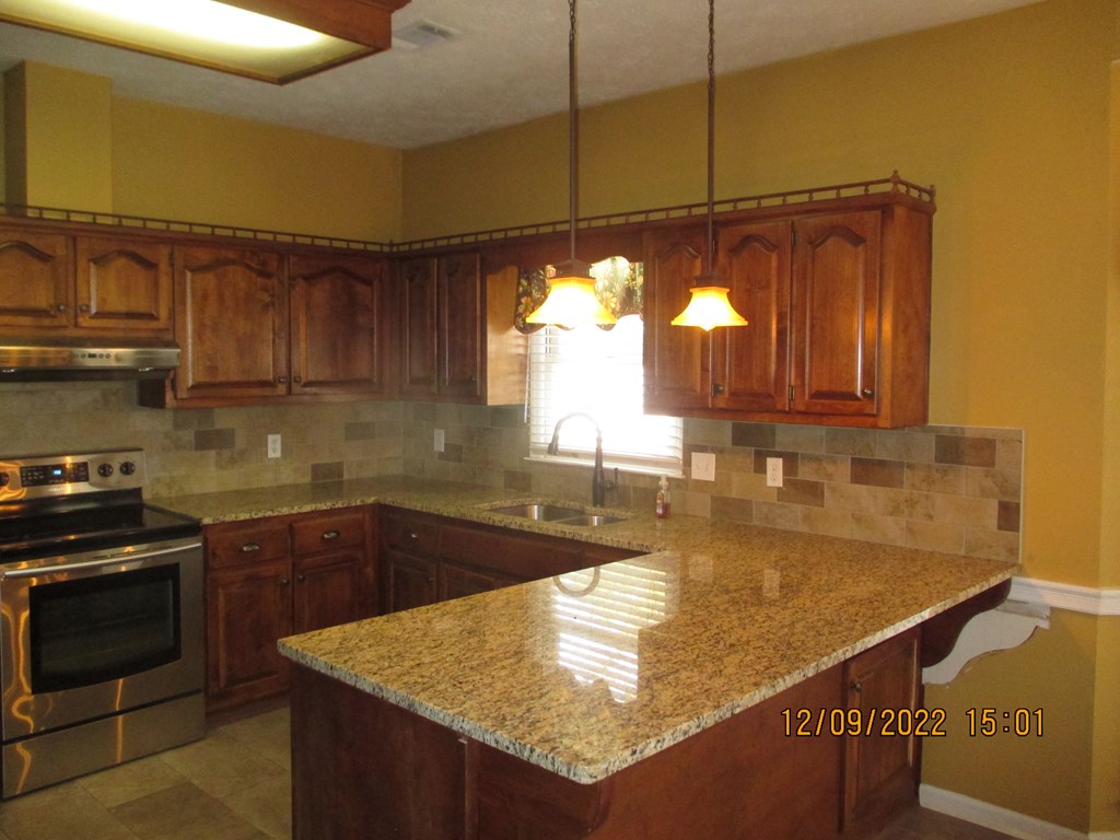 7201 West Wynfield Loop Midland, GA 31820 - Photo 11 of 34 a kitchen with a sink a counter top space cabinets and appliances