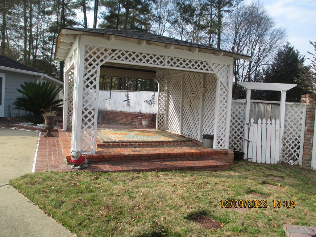 7201 West Wynfield Loop Midland, GA 31820 - Photo 15 of 34 a front view of a house with garden