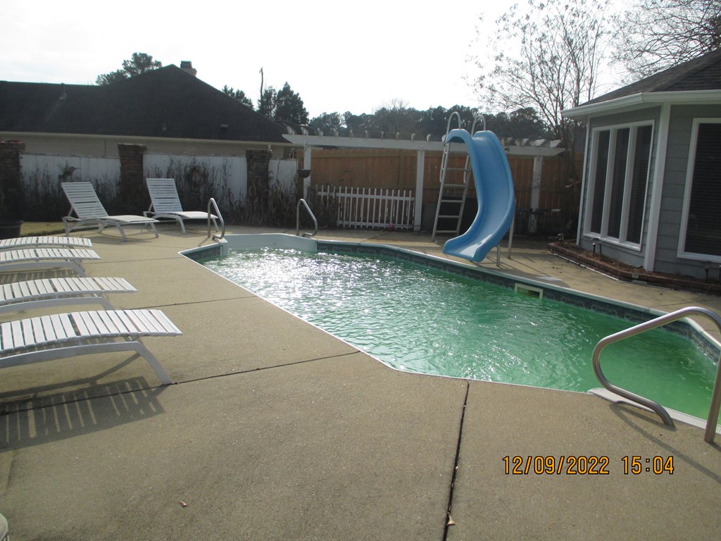 7201 West Wynfield Loop Midland, GA 31820 - Photo 16 of 34 a backyard of a house with barbeque oven and wooden fence