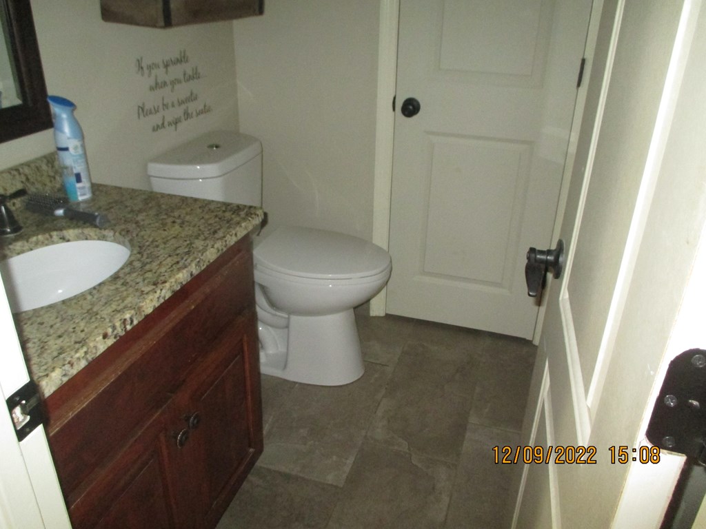 7201 West Wynfield Loop Midland, GA 31820 - Photo 20 of 34 a bathroom with a granite countertop sink a toilet and shower