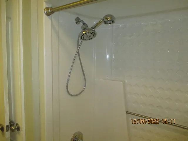 a bathroom with a glass shower door