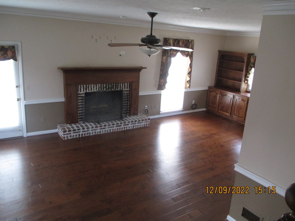 7201 West Wynfield Loop Midland, GA 31820 - Photo 31 of 34 a living room with hard wood floors and a fireplace