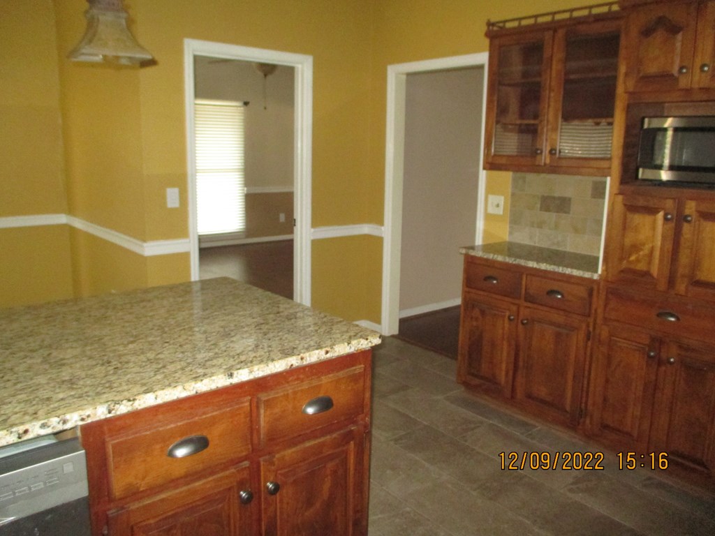 7201 West Wynfield Loop Midland, GA 31820 - Photo 32 of 34 a view of granite countertop cabinets and sink