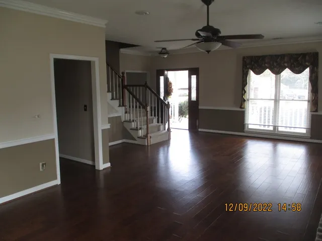 a view of a livingroom with wooden floor and a window