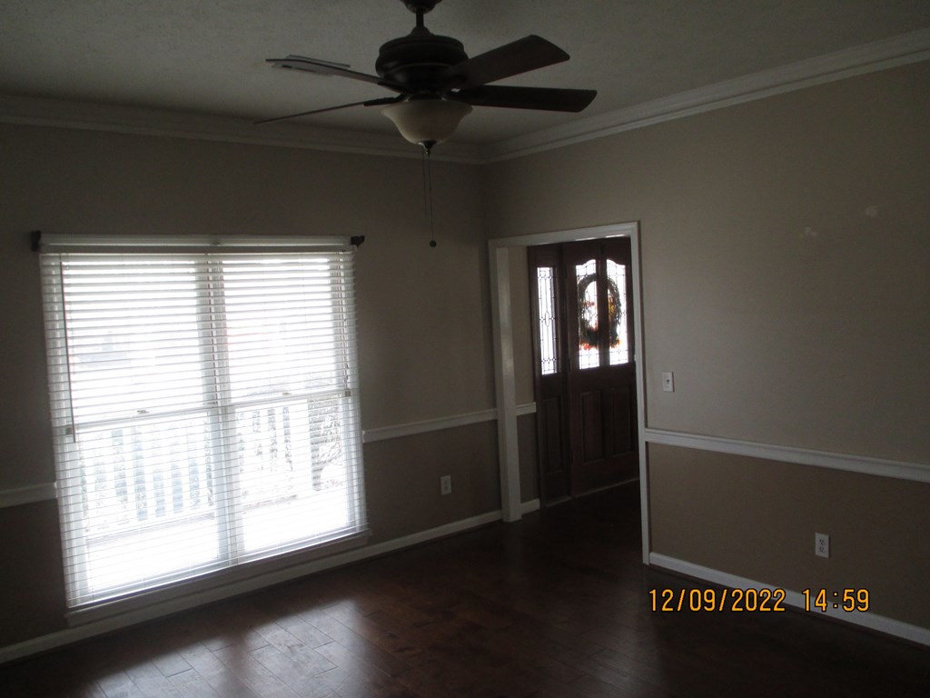 7201 West Wynfield Loop Midland, GA 31820 - Photo 9 of 34 a view of an empty room with wooden floor and a window