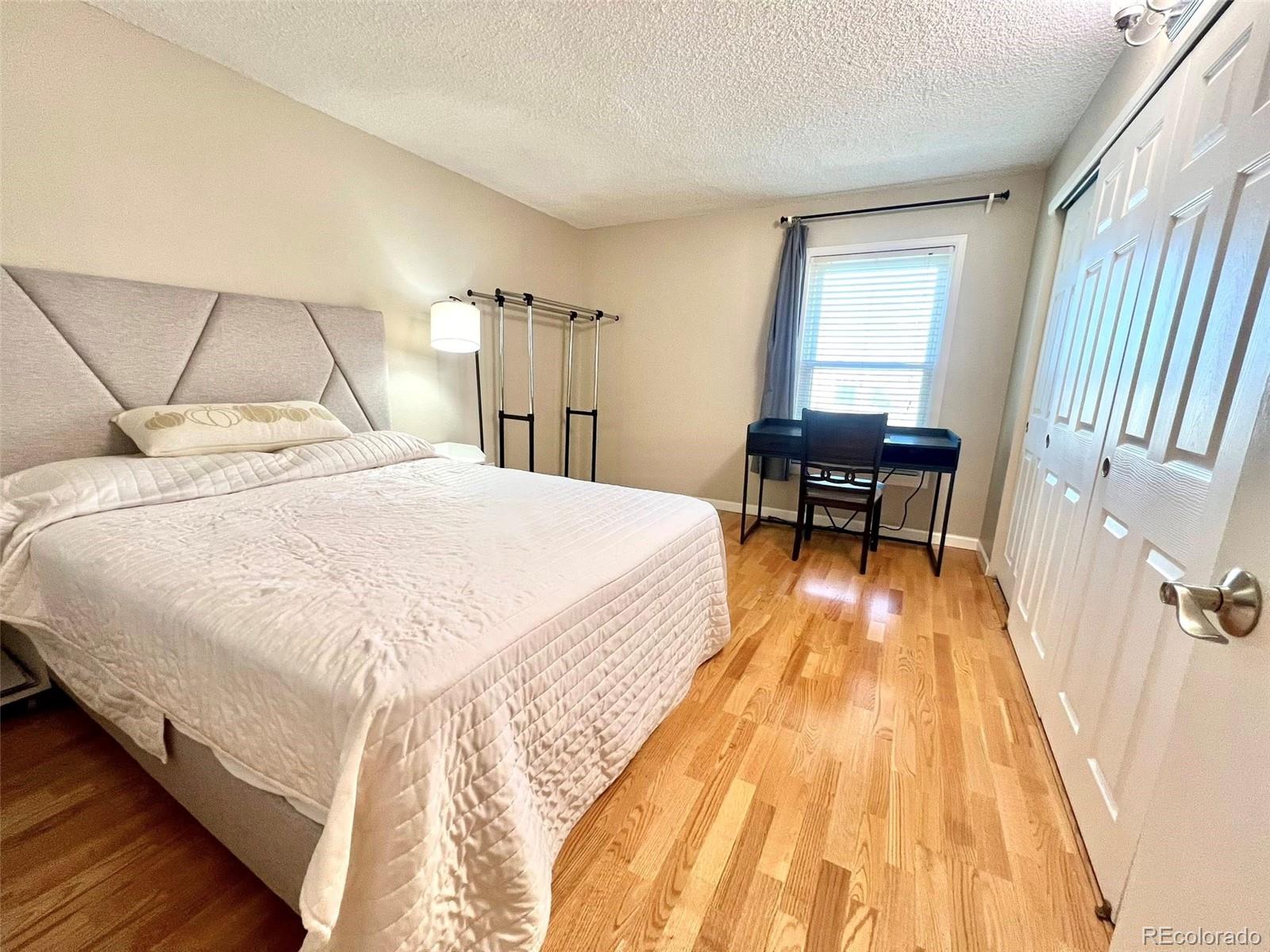 2 Adams Street, Unit 604 Denver, CO 80206 - Photo 17 of 41 a bed sitting in a bedroom next to a window