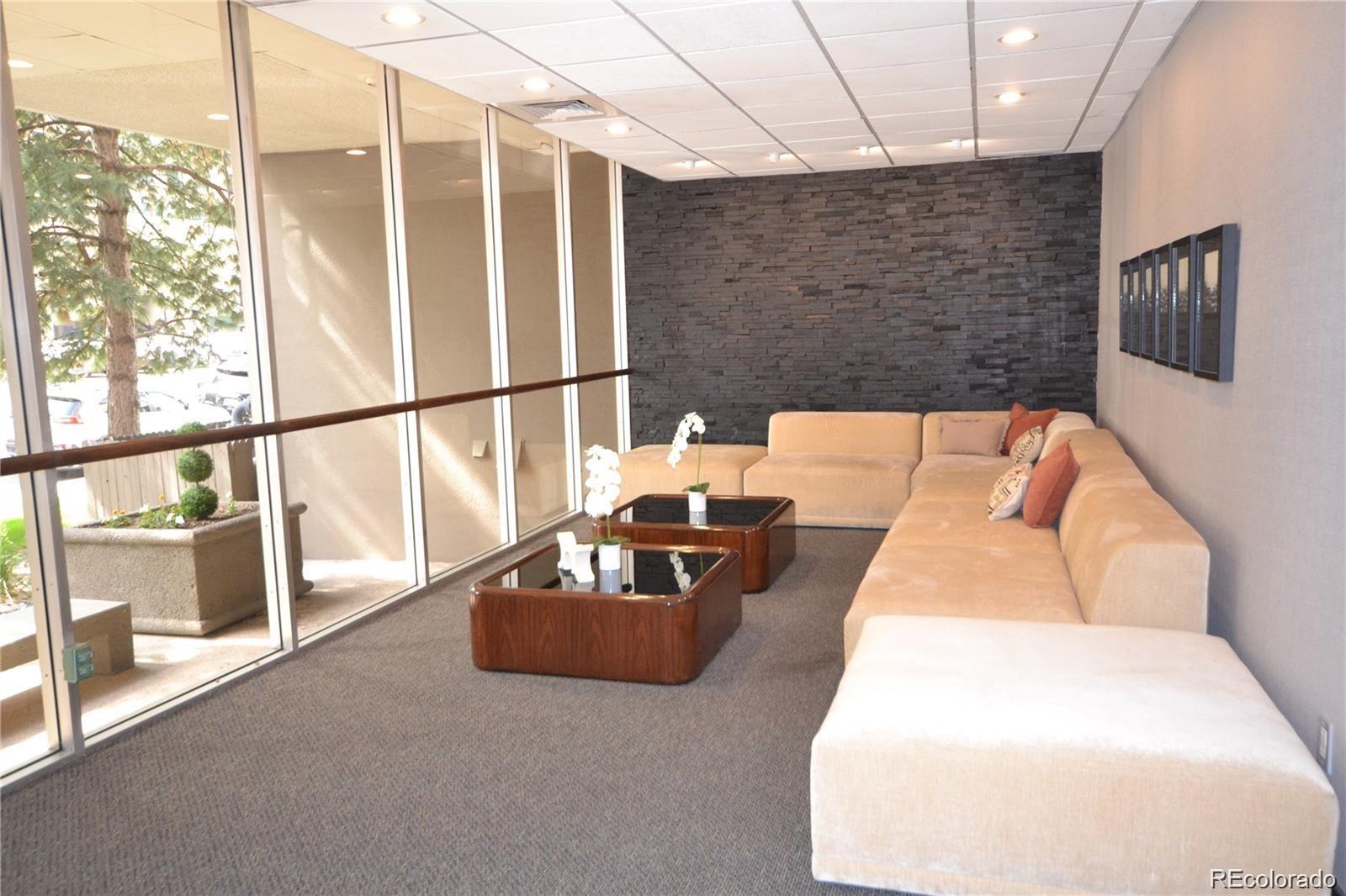 2 Adams Street, Unit 604 Denver, CO 80206 - Photo 23 of 41 a living room with furniture and a floor to ceiling window