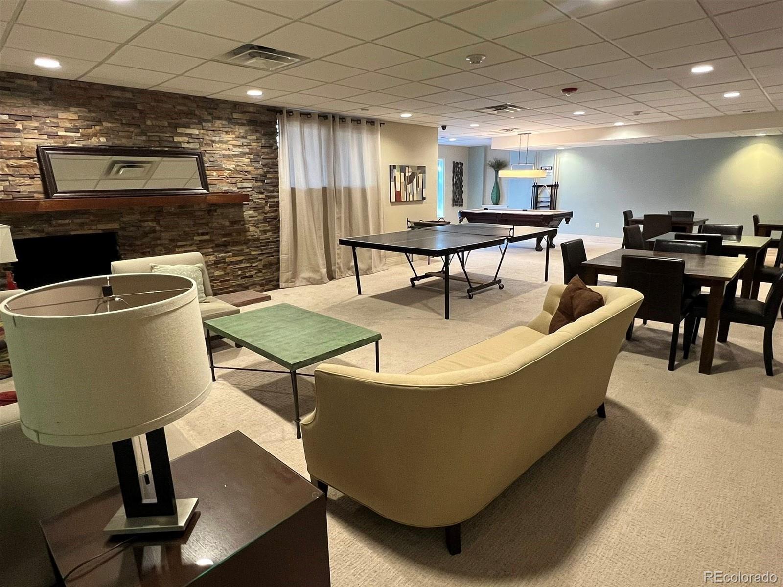 2 Adams Street, Unit 604 Denver, CO 80206 - Photo 26 of 41 a living room with a table a table and chairs