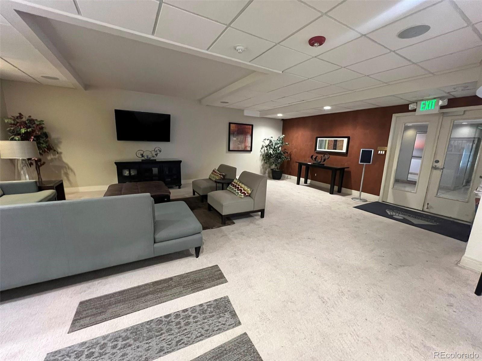 2 Adams Street, Unit 604 Denver, CO 80206 - Photo 30 of 41 a living room with furniture and a flat screen tv