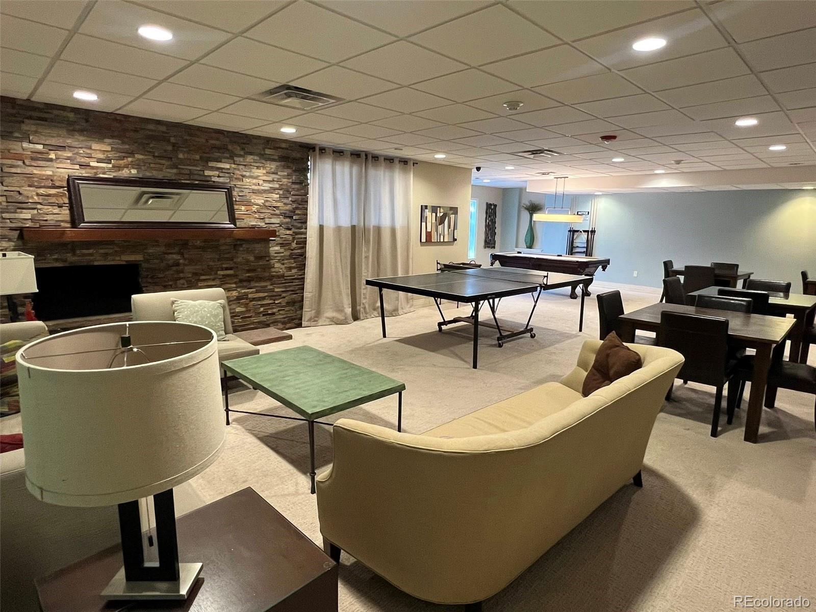 2 Adams Street, Unit 604 Denver, CO 80206 - Photo 31 of 41 a living room with couches chairs and a potted plant
