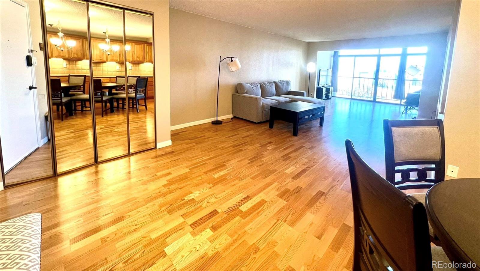 2 Adams Street, Unit 604 Denver, CO 80206 - Photo 5 of 41 a living room with furniture and a floor to ceiling window
