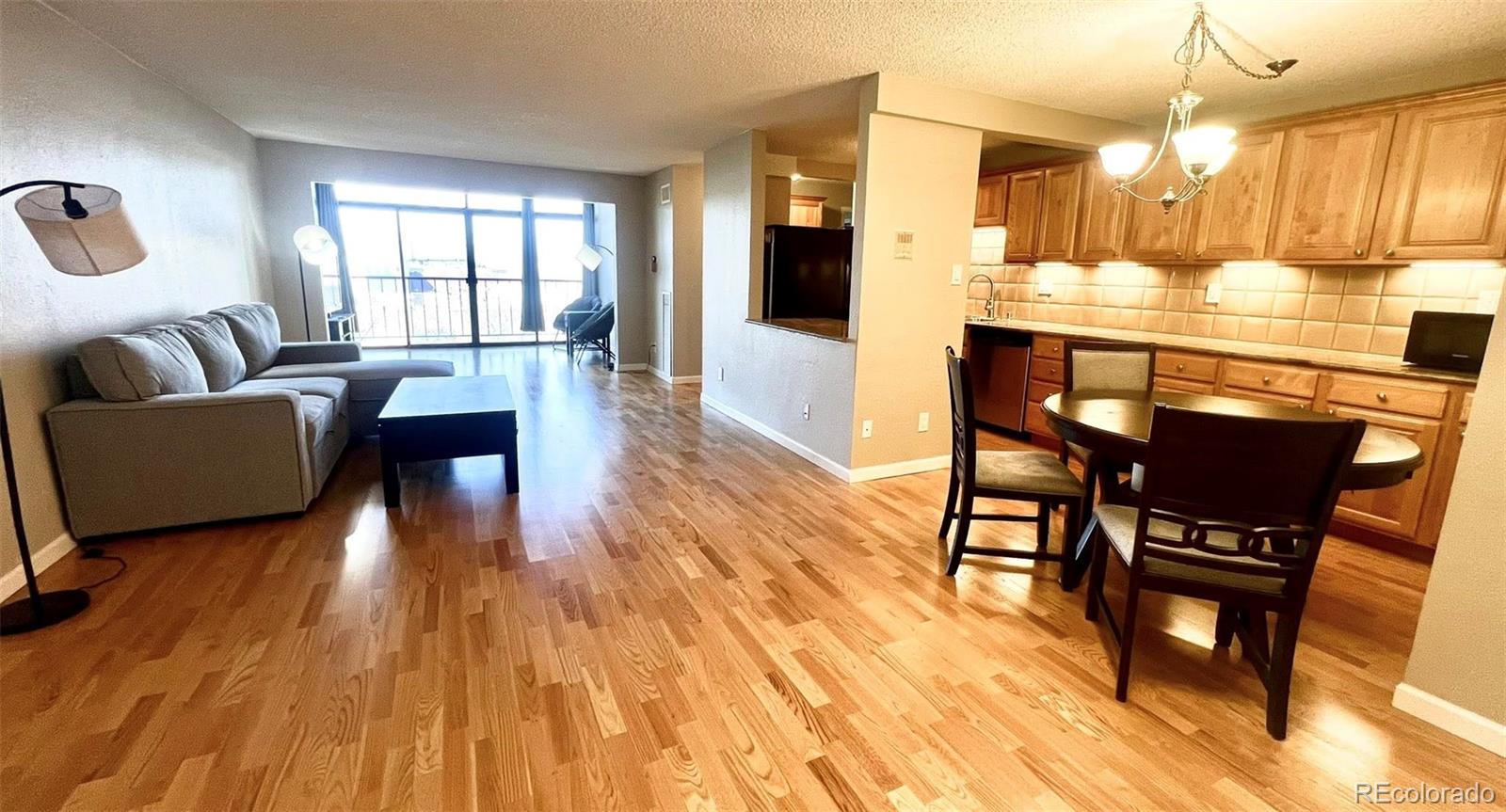2 Adams Street, Unit 604 Denver, CO 80206 - Photo 6 of 41 a living room with furniture and a wooden floor