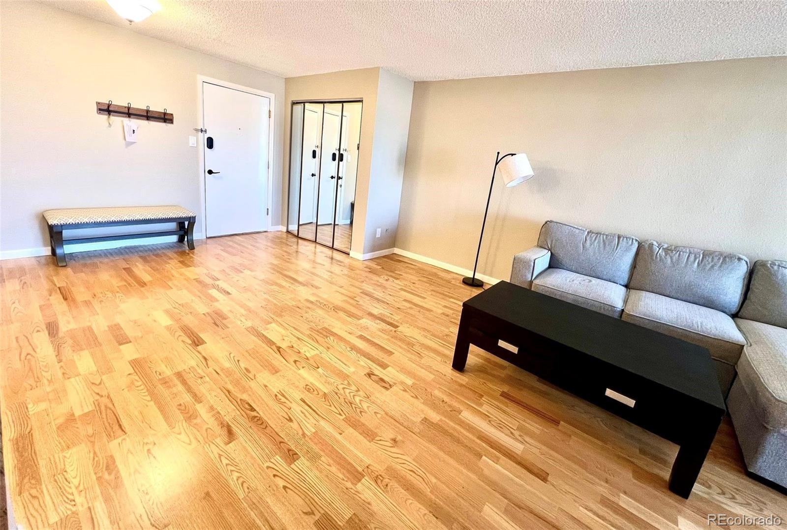 2 Adams Street, Unit 604 Denver, CO 80206 - Photo 7 of 41 a bedroom with a bed and wooden floor