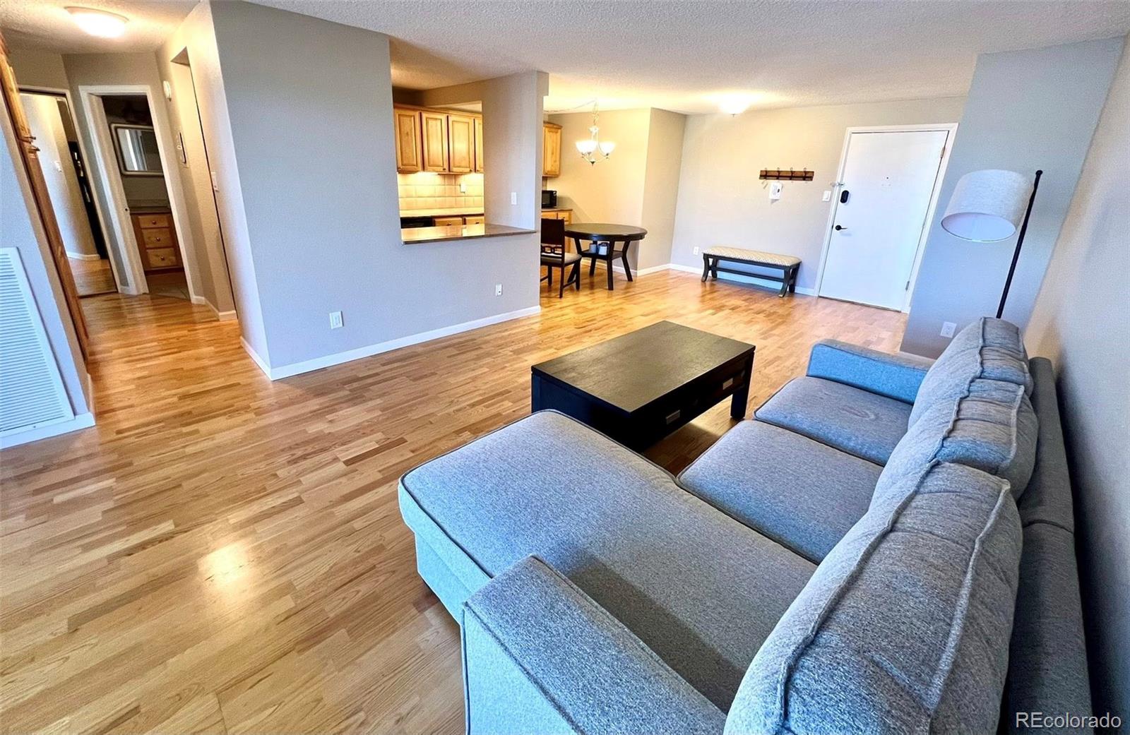 2 Adams Street, Unit 604 Denver, CO 80206 - Photo 9 of 41 a living room with furniture and a wooden floor