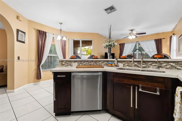 a kitchen with a sink a counter space and a window
