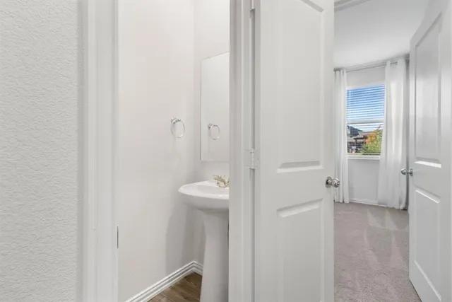 an empty room with a ceiling fan and a window