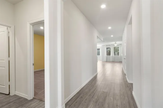 a view of a hallway with wooden floor
