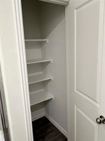 a view of a backyard with potted plants and wooden fence