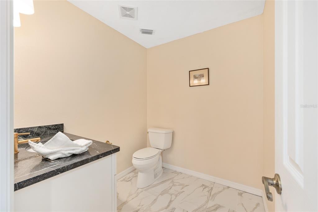 8778 Northwest 130th Street Reddick, FL 32686 - Photo 16 of 88 a bathroom with a granite countertop sink and a toilet