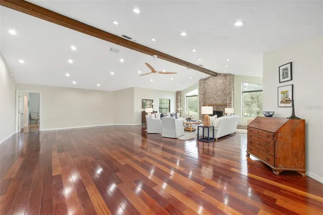 a living room with fireplace furniture and a wooden floor