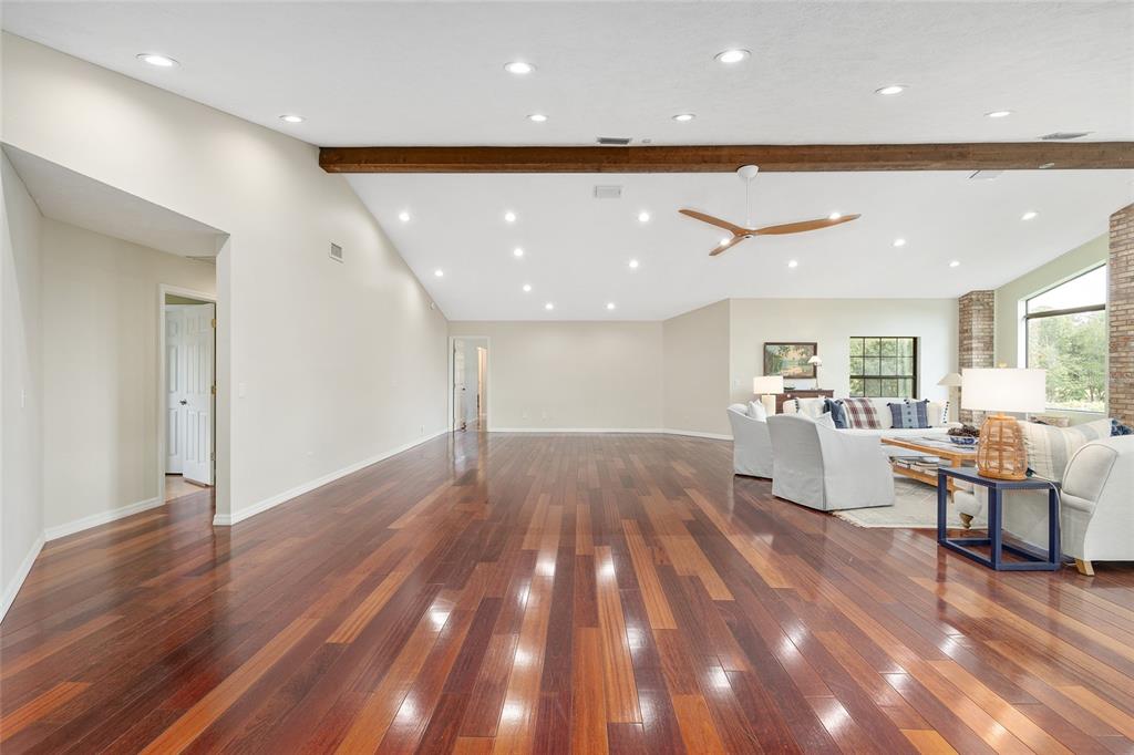 8778 Northwest 130th Street Reddick, FL 32686 - Photo 18 of 88 a view of a big room with wooden floor and windows