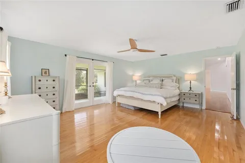 a bathroom with a granite countertop double vanity sink and a mirror