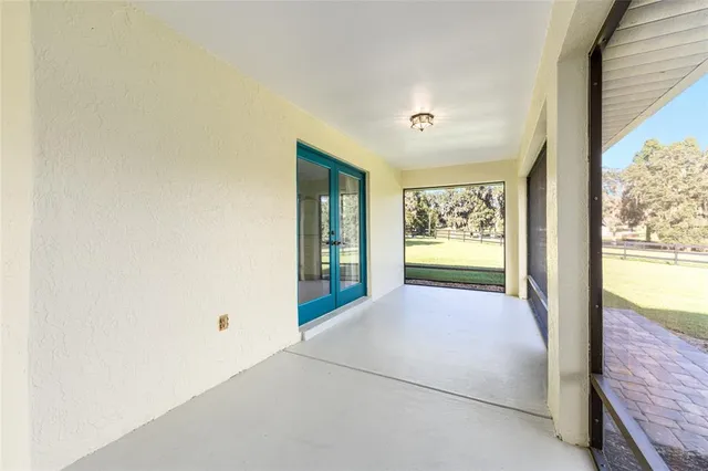 a spacious bedroom with a bed and a chandelier