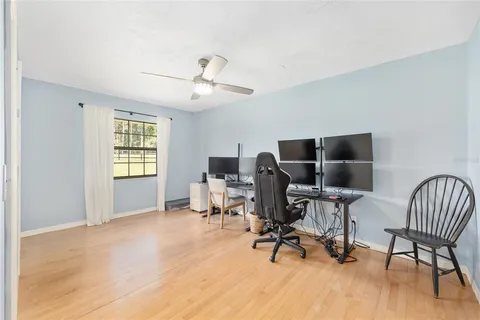 a spacious bathroom with a granite countertop toilet a sink and a mirror