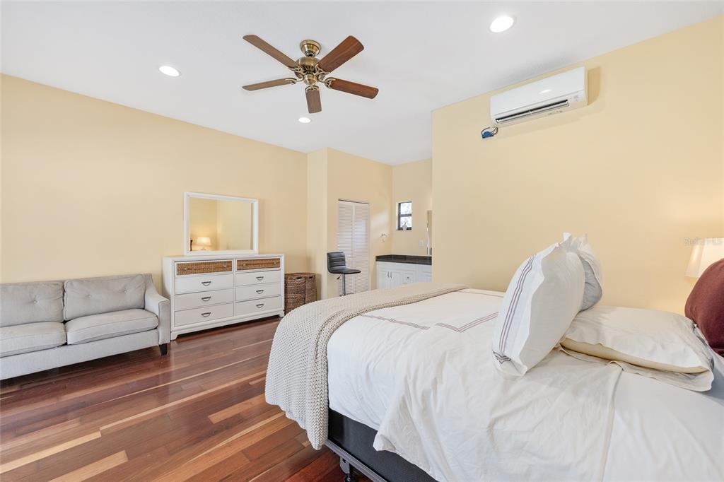 8778 Northwest 130th Street Reddick, FL 32686 - Photo 44 of 88 a spacious bedroom with a bed and a couch