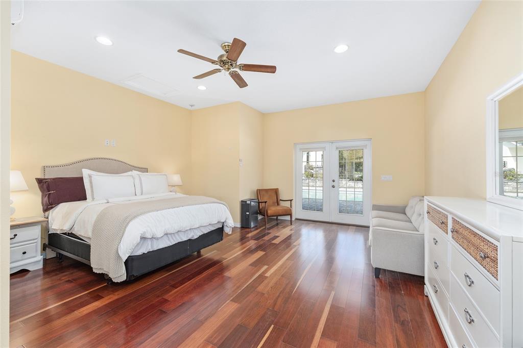 8778 Northwest 130th Street Reddick, FL 32686 - Photo 45 of 88 a spacious bedroom with a bed and a chandelier