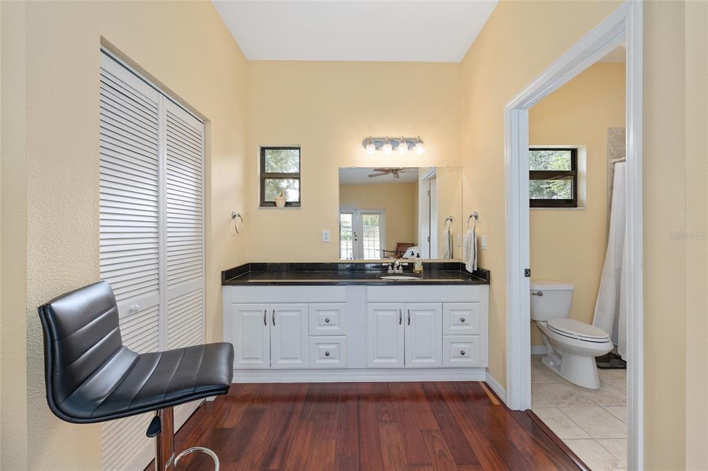 8778 Northwest 130th Street Reddick, FL 32686 - Photo 46 of 88 a spacious bathroom with a granite countertop toilet a sink and a mirror