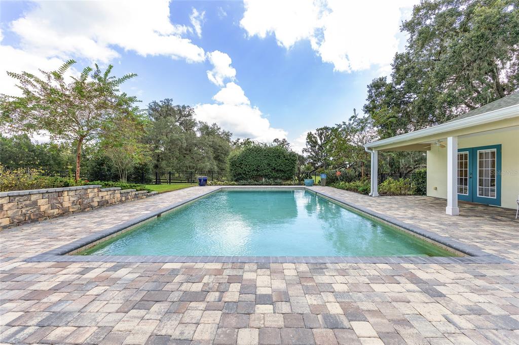 8778 Northwest 130th Street Reddick, FL 32686 - Photo 49 of 88 a view of swimming pool on a sunny day with lawn chairs