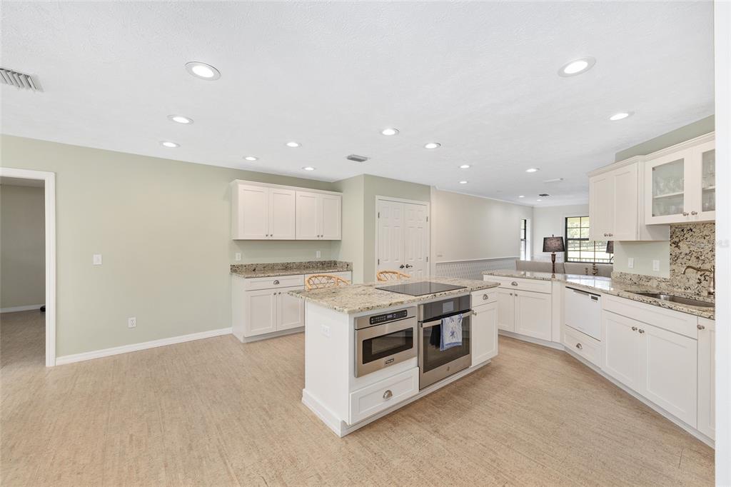 8778 Northwest 130th Street Reddick, FL 32686 - Photo 7 of 88 a large kitchen with stainless steel appliances granite countertop a stove a sink and a white cabinets
