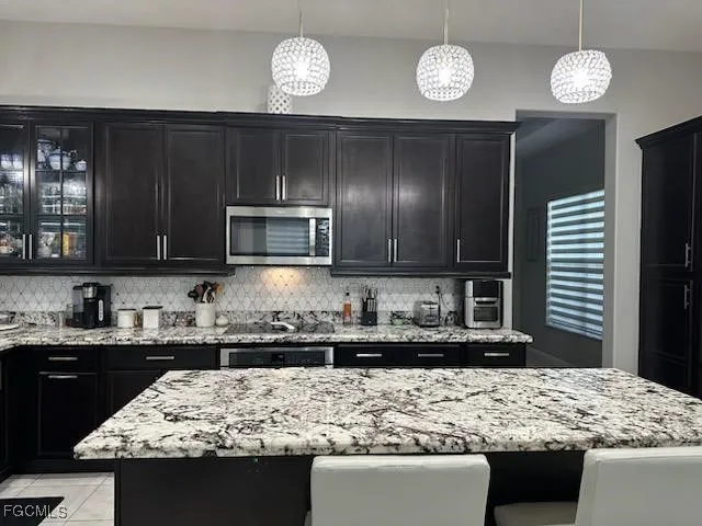 a kitchen with a sink and a stove top oven